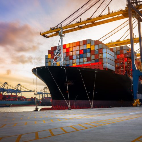 Crane loading Cargo Container export container ship in the international terminal logistics sea port concept freight shipping by ship, Truck running in port under the Big Crane transport trade